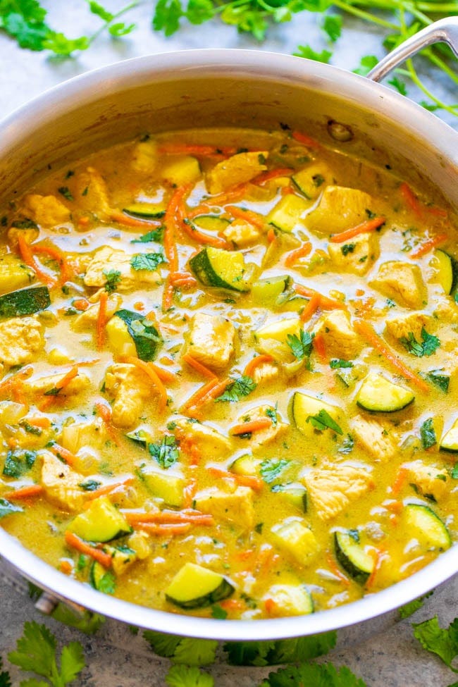overhead view of green chicken curry in a large skillet