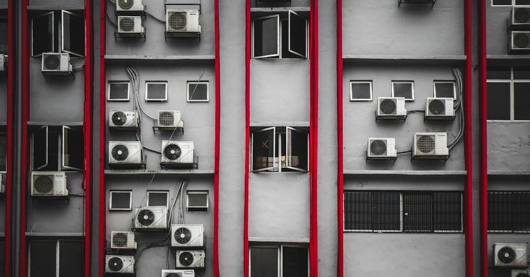 a bunch of air conditioners on a building