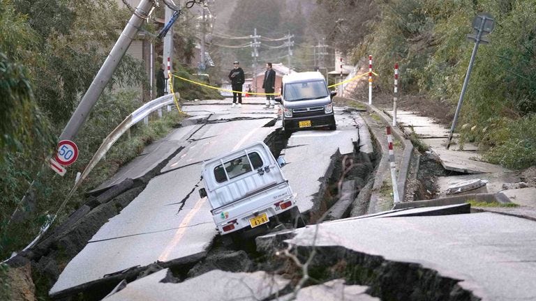 Bystanders look at damages somewhere near Noto town in the Noto peninsula facing the Sea of Japan, northwest of Tokyo, following Monday's deadly earthquake. Pic: AP Bystanders look at damages somewhere near Noto town in the Noto peninsula facing the Sea of Japan, northwest of Tokyo, following Monday's deadly earthquake. Pic: AP