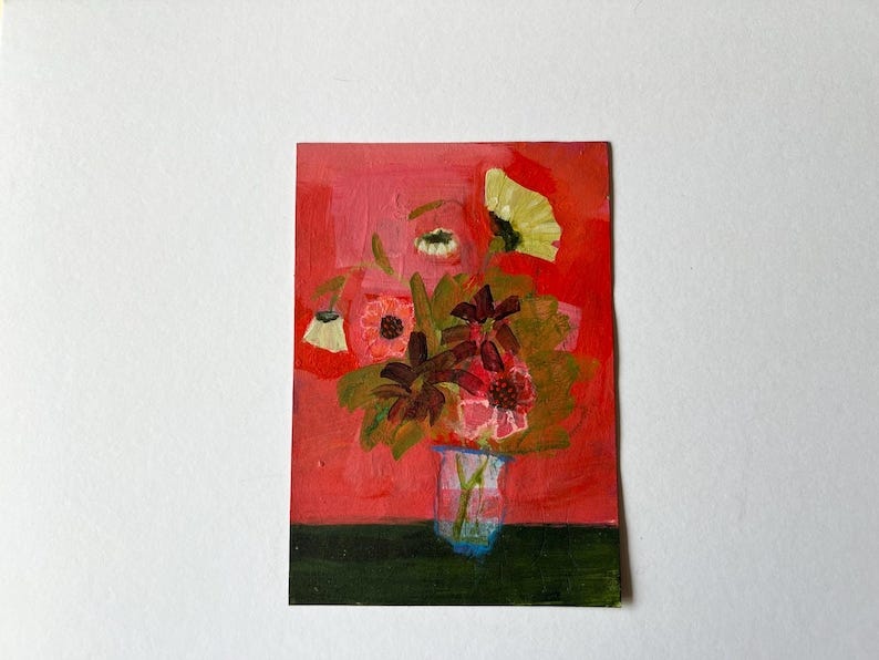 May include: An original floral painting on a rectangular canvas. The artwork features a bouquet of flowers in a clear vase against a red background. The flowers are in shades of pink, yellow, and green, with dark green leaves.