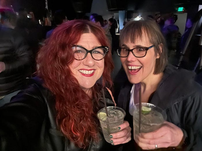 Two women in a bar, holding cocktails Two women in a bar, holding cocktails