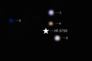 The clearest look in the infrared yet at the iconic multi-planet system HR 8799. Colors are applied to filters from Webb’s NIRCam (Near-Infrared Camera). A star symbol marks the location of the host star HR 8799, whose light has been blocked by the coronagraph. In this image, the color blue is assigned to 4.1 micron light, green to 4.3 micron light, and red to the 4.6 micron light