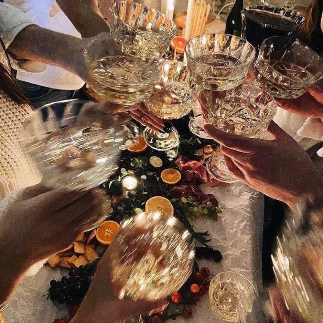 A photo of champagne glasses being clinked