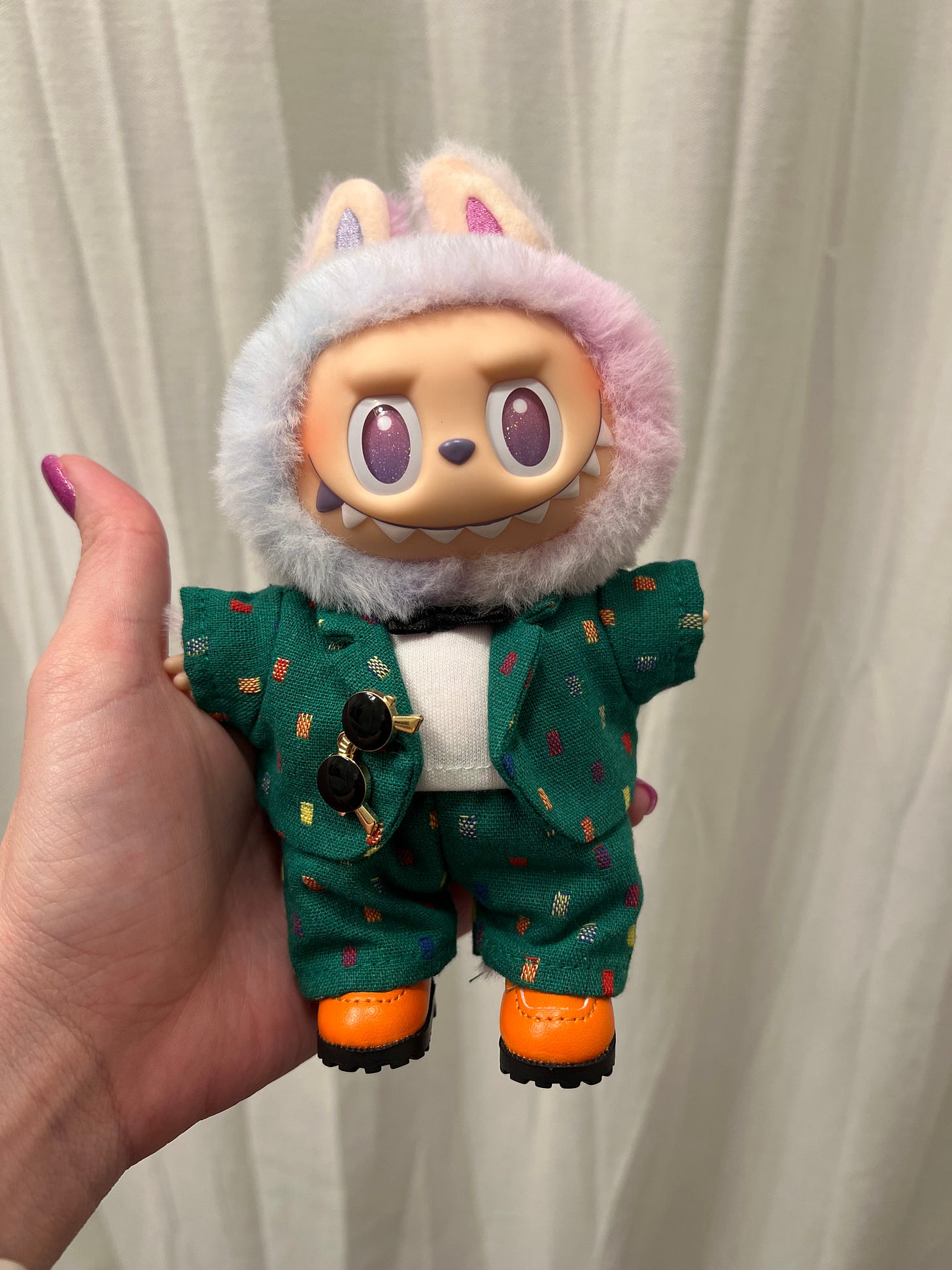 Labubu in a suit with a bow tie and loafers