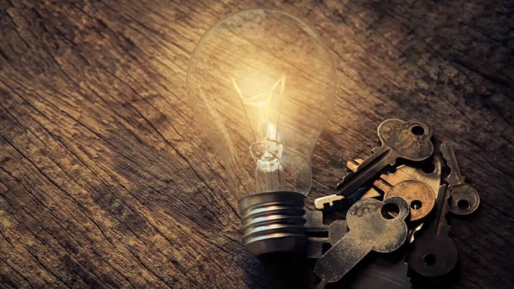 Light Bulb and Keys on Table Light Bulb and Keys on Table