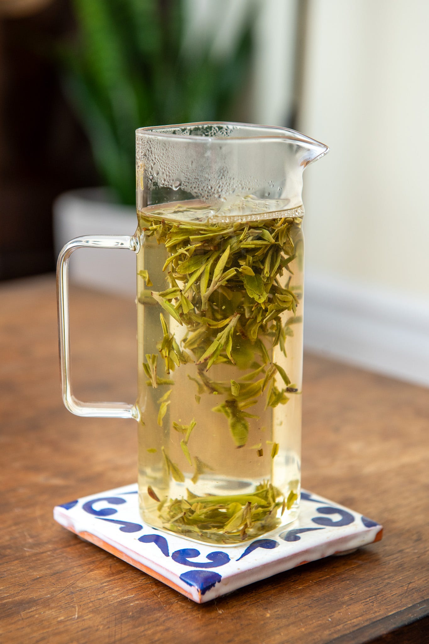 ID: Glass tea pitcher brewing green tea