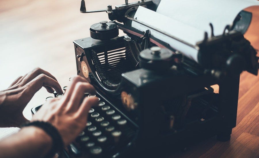 Typing on a typewriter Typing on a typewriter