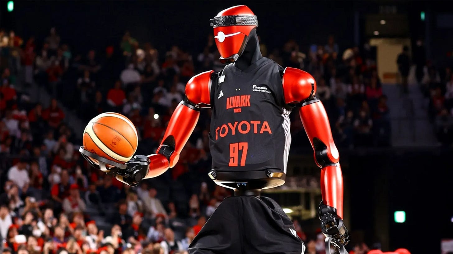 A red humanoid robot in a basketball jersey looks at a ball in his hand