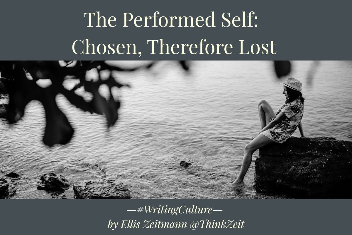 Black and white photograph of a woman seated on rocks at the water's edge, turned away from the viewer toward open water, a tree's dark branches dissolving into the surface above her. Overlaid with the series title 'The Performed Self' and the hook 'Chosen, Therefore Lost.' Part of The Performed Self series on the impossibility of escaping self-construction.