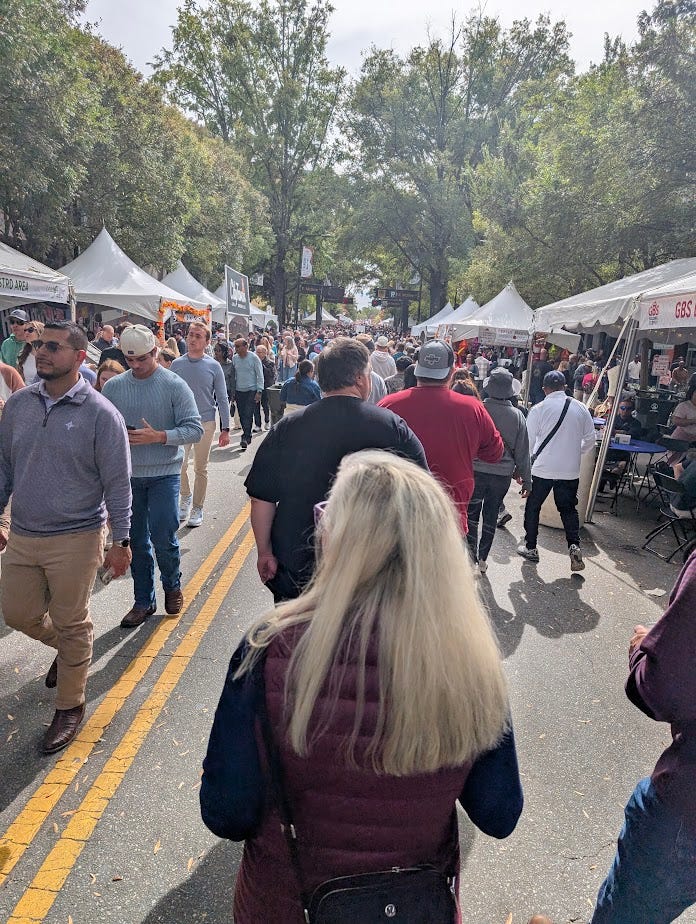 People walking down a street festival in the South