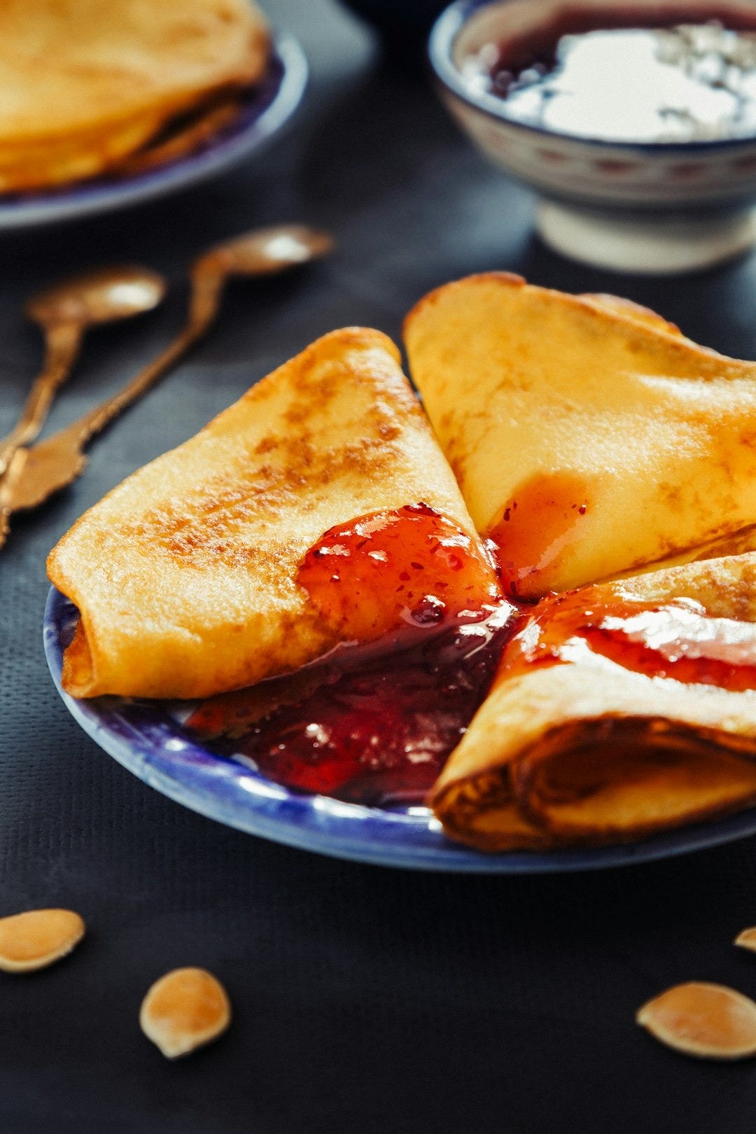 a plate of food with crepes and sauce on it a plate of food with crepes and sauce on it