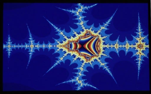 Bilaterally symmetrical spiky fractal image with a bright yellow-orange central structure that tapers off in dozens of dwindling spindles into a dark blue sea of microscopically infinite mathematical propagation. Bilaterally symmetrical spiky fractal image with a bright yellow-orange central structure that tapers off in dozens of dwindling spindles into a dark blue sea of microscopically infinite mathematical propagation.