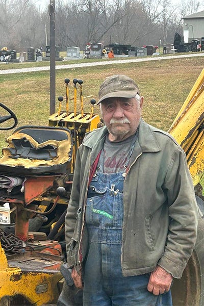 Allen stood by his tractor