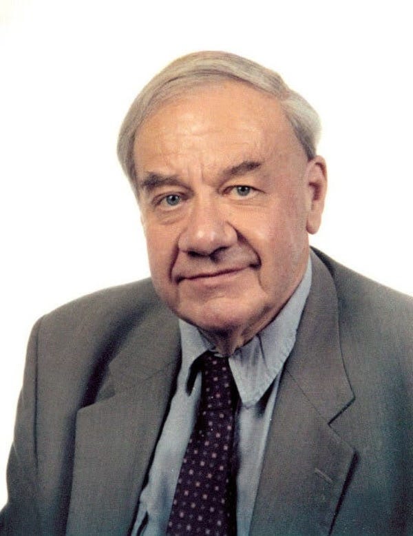 A picture of the late physicist Ronald Drever. A nice, calm smile, a suit and a tie.