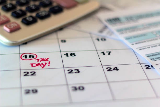 Tax day marked on calendar, calculator and tax form Tax day marked on calendar, calculator and tax form on desk Tax Returns on Extension Are Due October 15 stock pictures, royalty-free photos & images