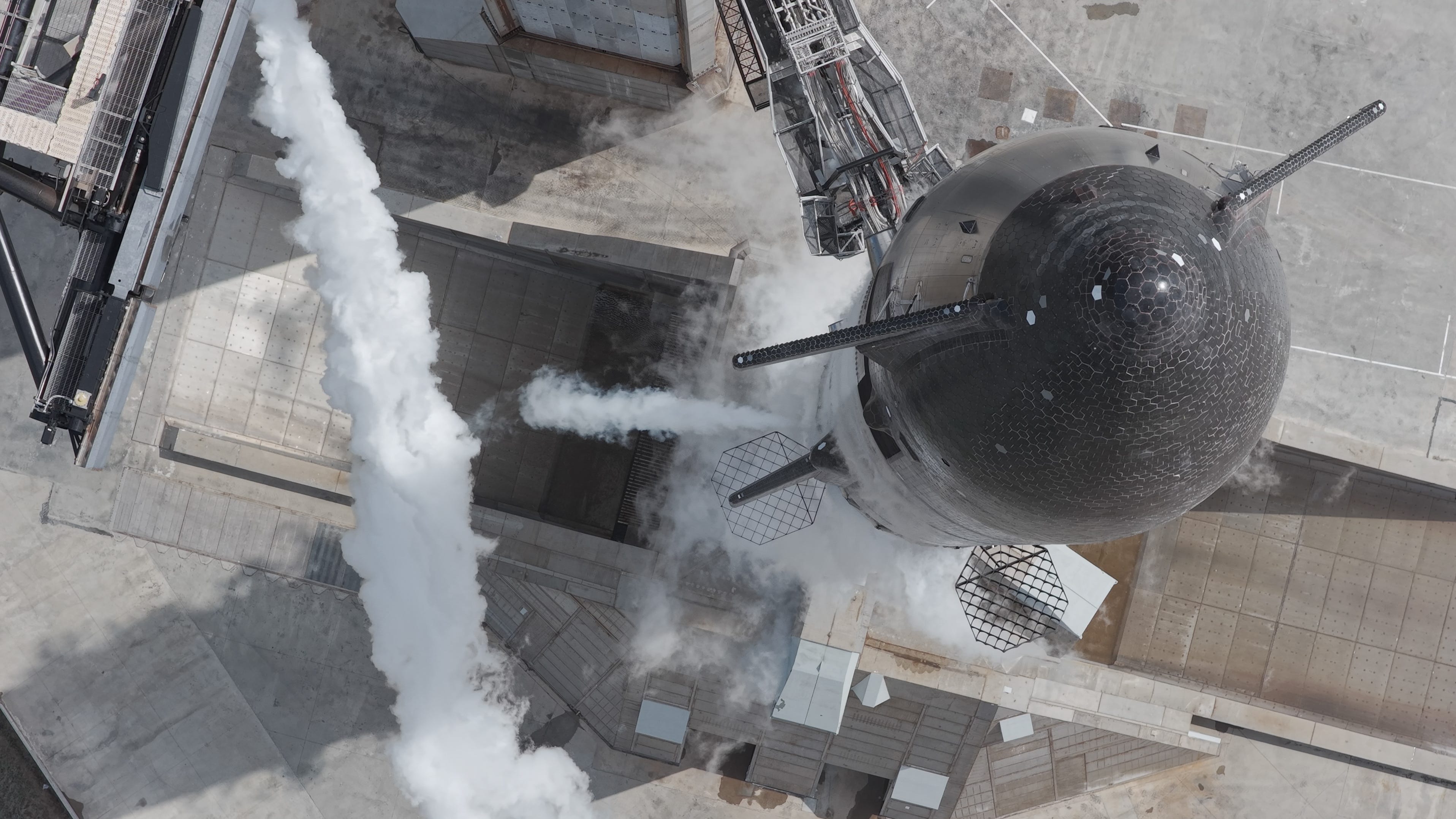 a top-down vieo of a giant silver and black rocket