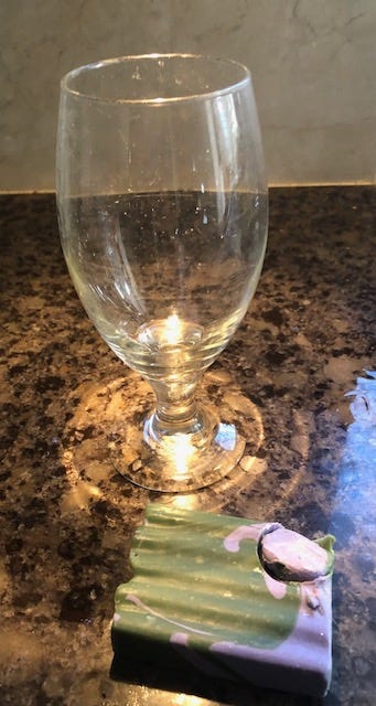 A glass on a counter

Description automatically generated