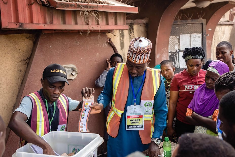Two men holding a ballot paper Two men holding a ballot paper