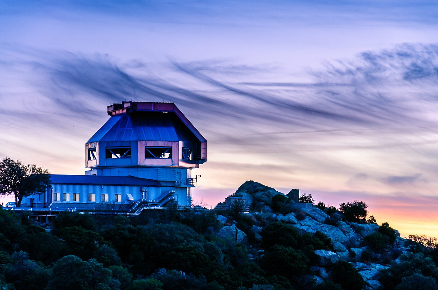 Observatory building on a hill at sunset.
