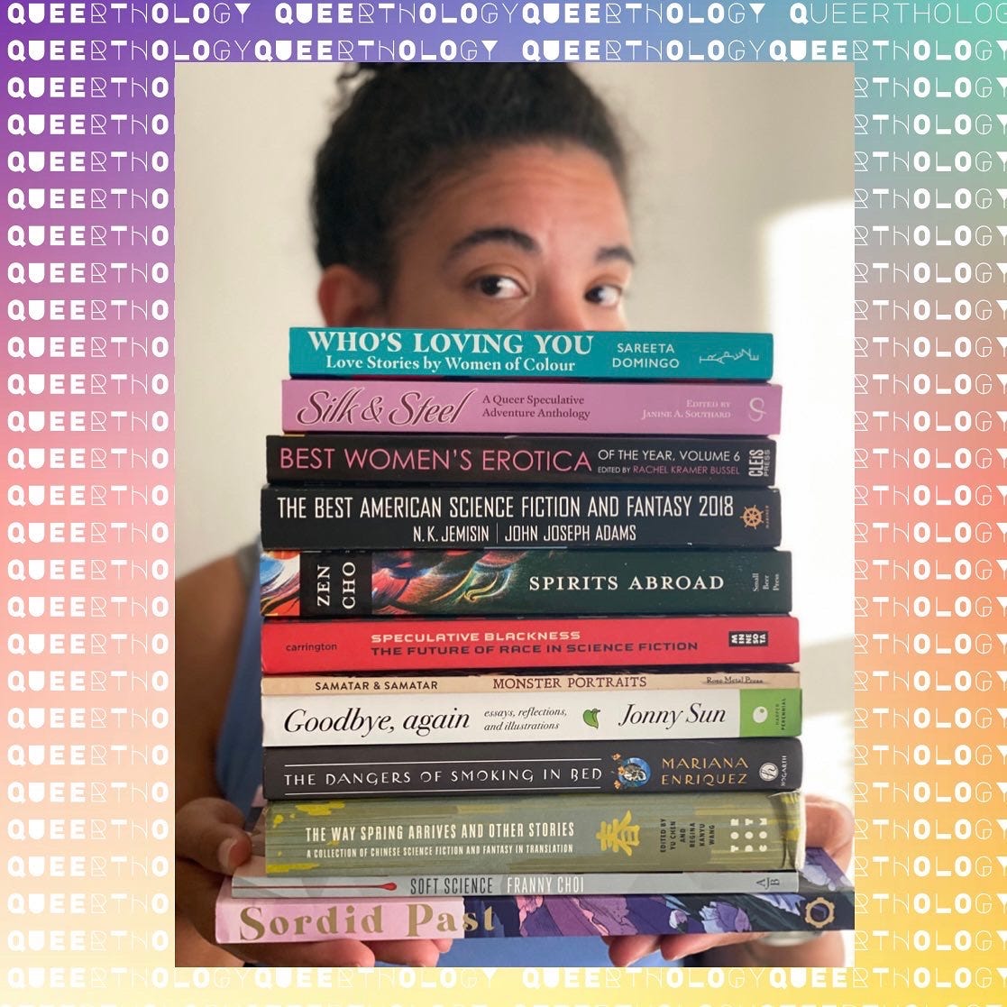 Kris holding a stack of books writeen by queer authors. Kris holding a stack of books writeen by queer authors.