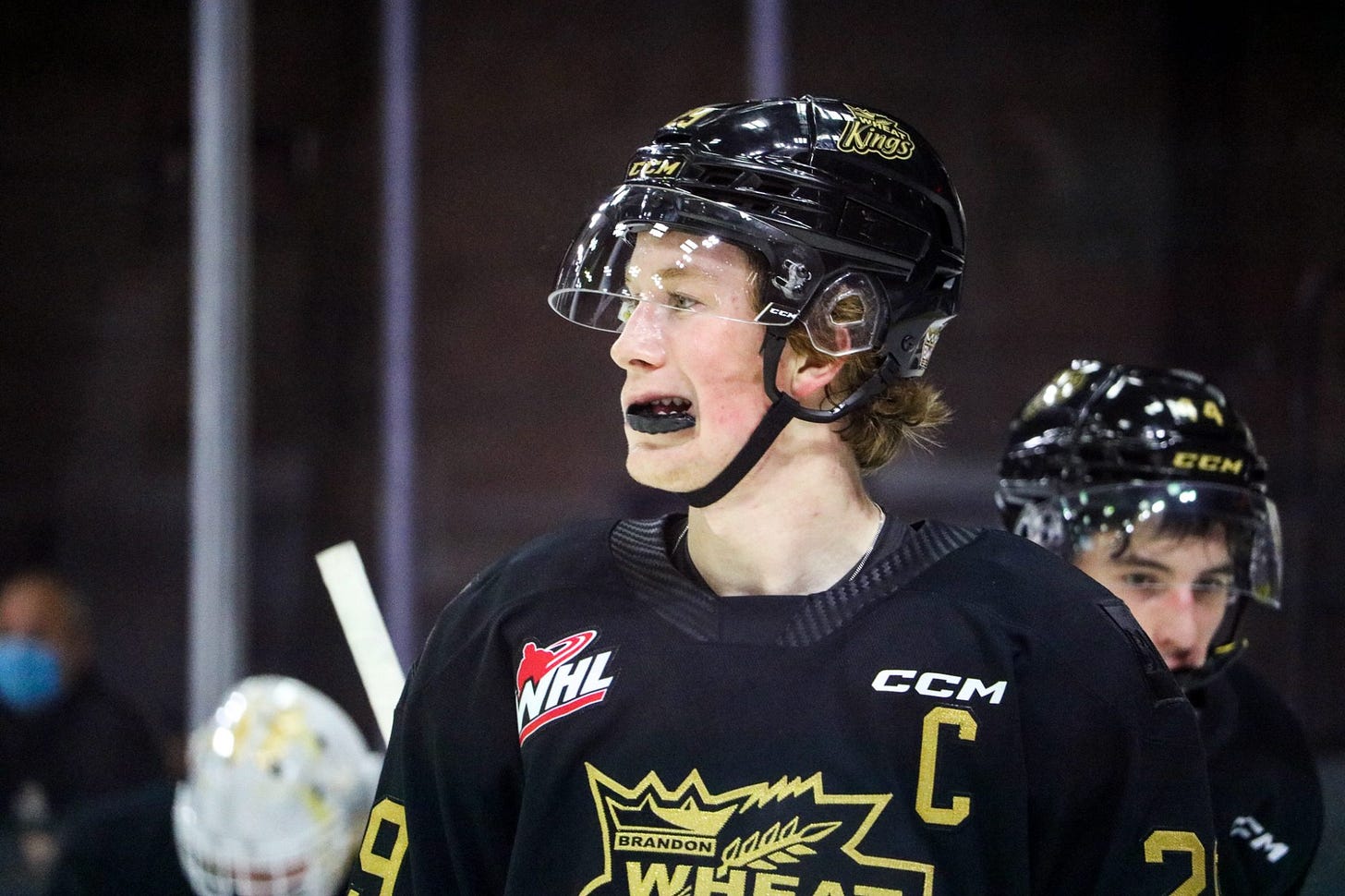 Nate Danielson standing around and chewing on his mouthpiece during a game.