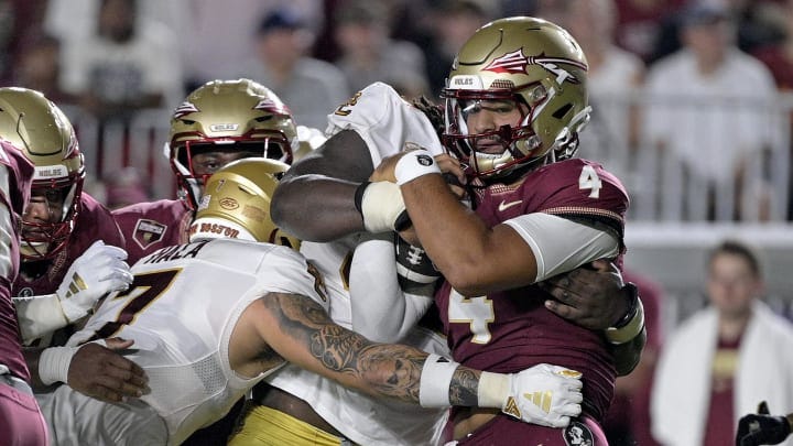 Sep 2, 2024; Tallahassee, Florida, USA; Florida State Seminoles quarterback DJ Uiagalelei (4) is tackled against the Boston College Eagles at Doak S. Campbell Stadium. Mandatory Credit: Melina Myers-USA TODAY Sports Sep 2, 2024; Tallahassee, Florida, USA; Florida State Seminoles quarterback DJ Uiagalelei (4) is tackled against the Boston College Eagles at Doak S. Campbell Stadium. Mandatory Credit: Melina Myers-USA TODAY Sports