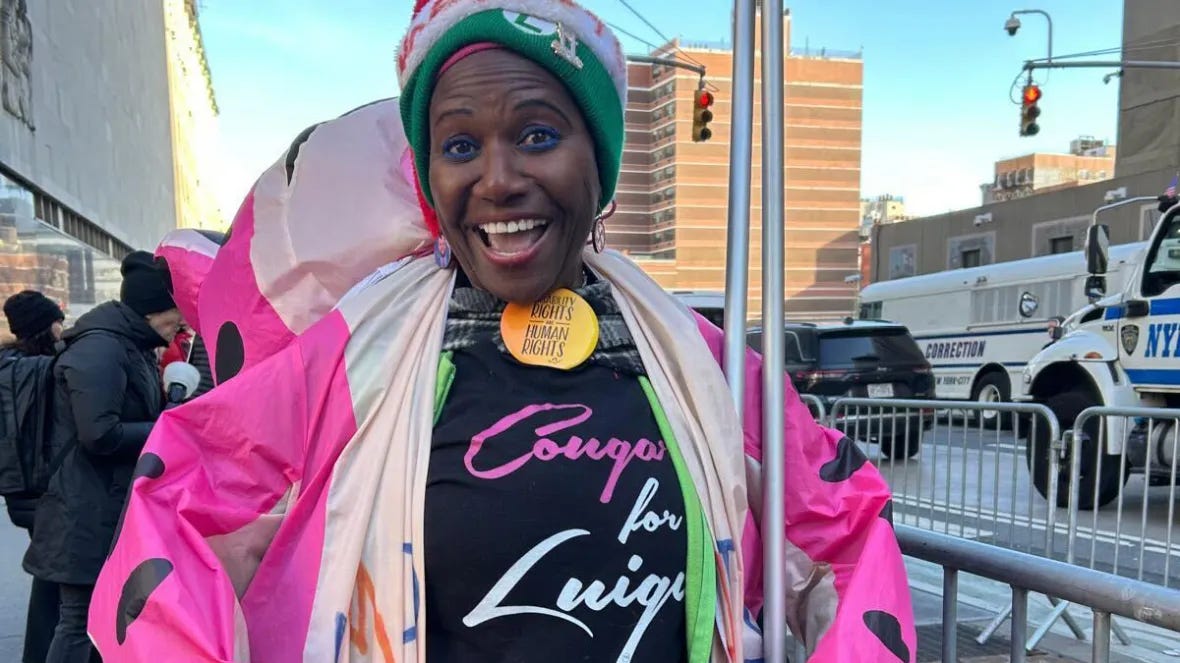 Nadine Seiler in a pink and black cow-print jumpsuit with a "Cougar for Luigi" shirt.