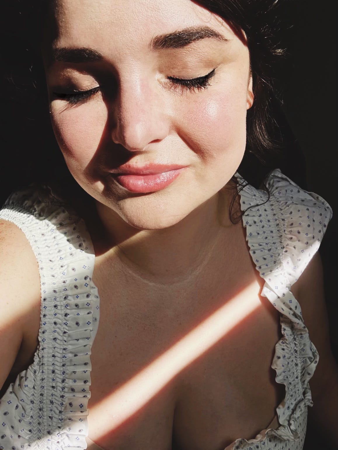 A picture of me, eyes closed, my 40 year old face in a sunbeam