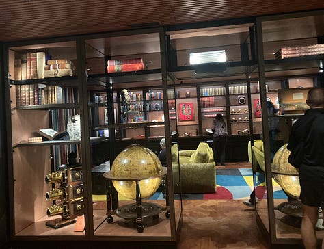 A series of nine photos inside the new library at MONA art museum shows shelves of books, reading lounges, cheeky covers, artist books, globes and more.