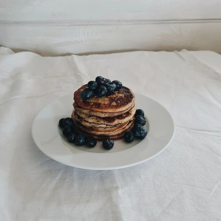 Banana and sourdough pancakes with blueberries and honey