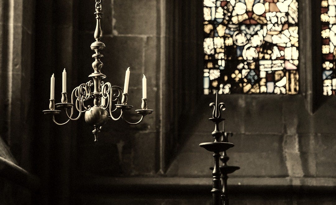 candle chandelier inside a cathedral