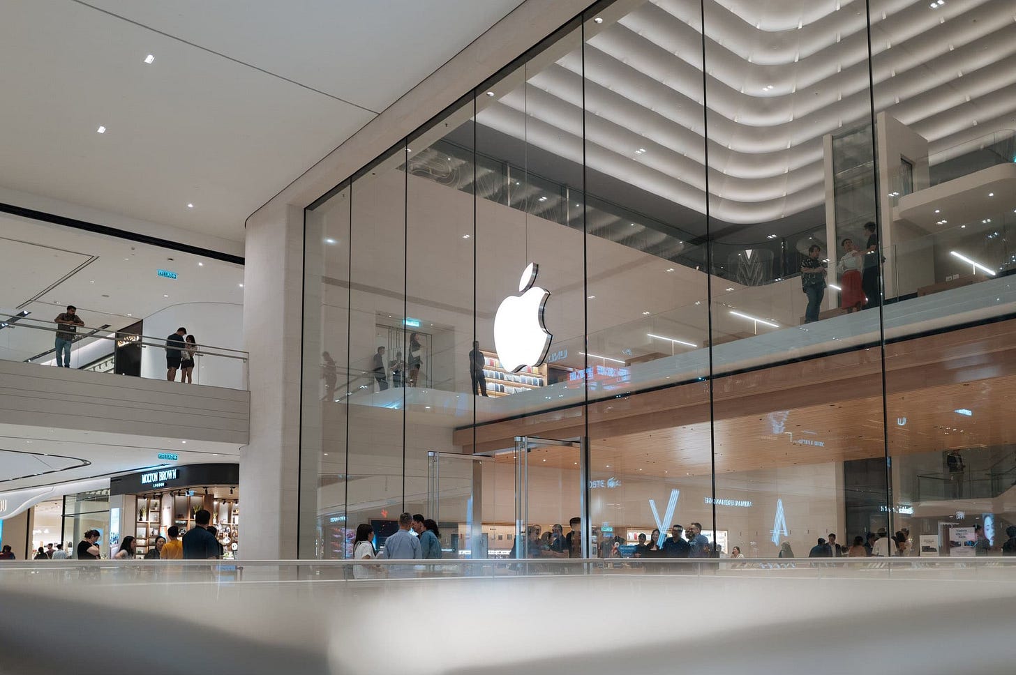 The main mall entrance to Apple The Exchange TRX, viewed from a low angle. The main mall entrance to Apple The Exchange TRX, viewed from a low angle.
