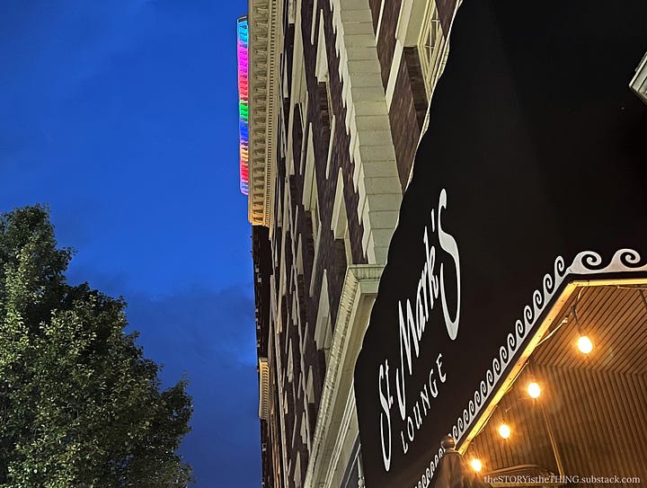 Four views of a downtown apartment building all light up in Pride Month colors in Huntington, West Virginia.