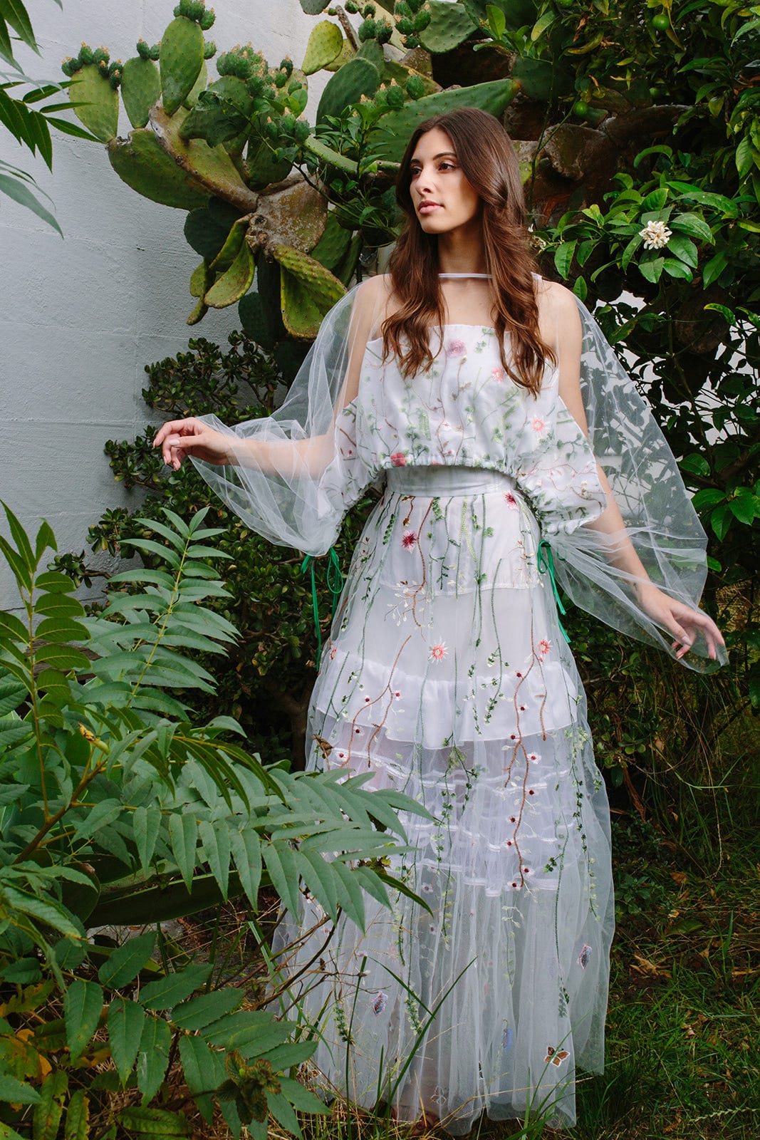 A model dressed up in diaphanous top and skirt made with upcycled embroidered tulle pieces by Mira Musank. A model dressed up in diaphanous top and skirt made with upcycled embroidered tulle pieces by Mira Musank.