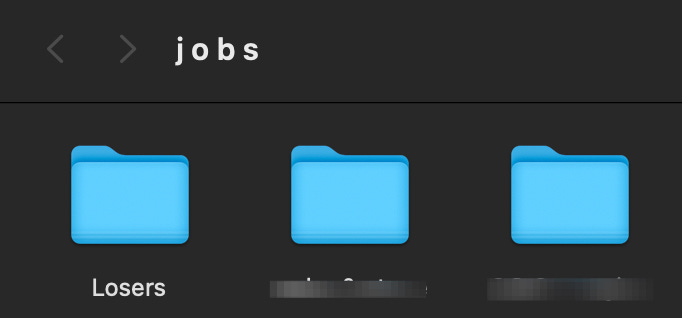 A screenshot of my "jobs" folder close up on my "losers" folder next to two other folders that I've redacted.