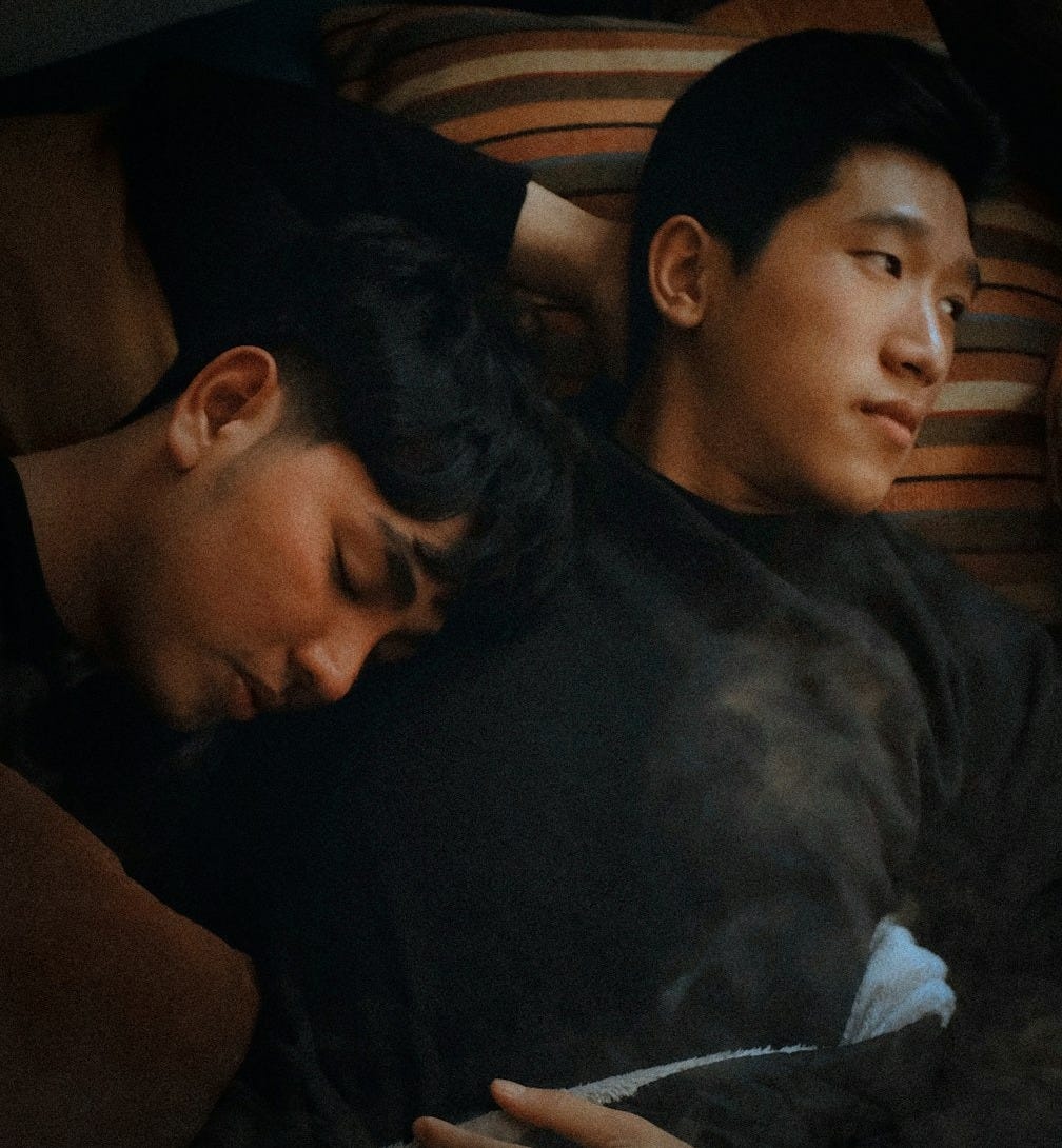 man lying beside man