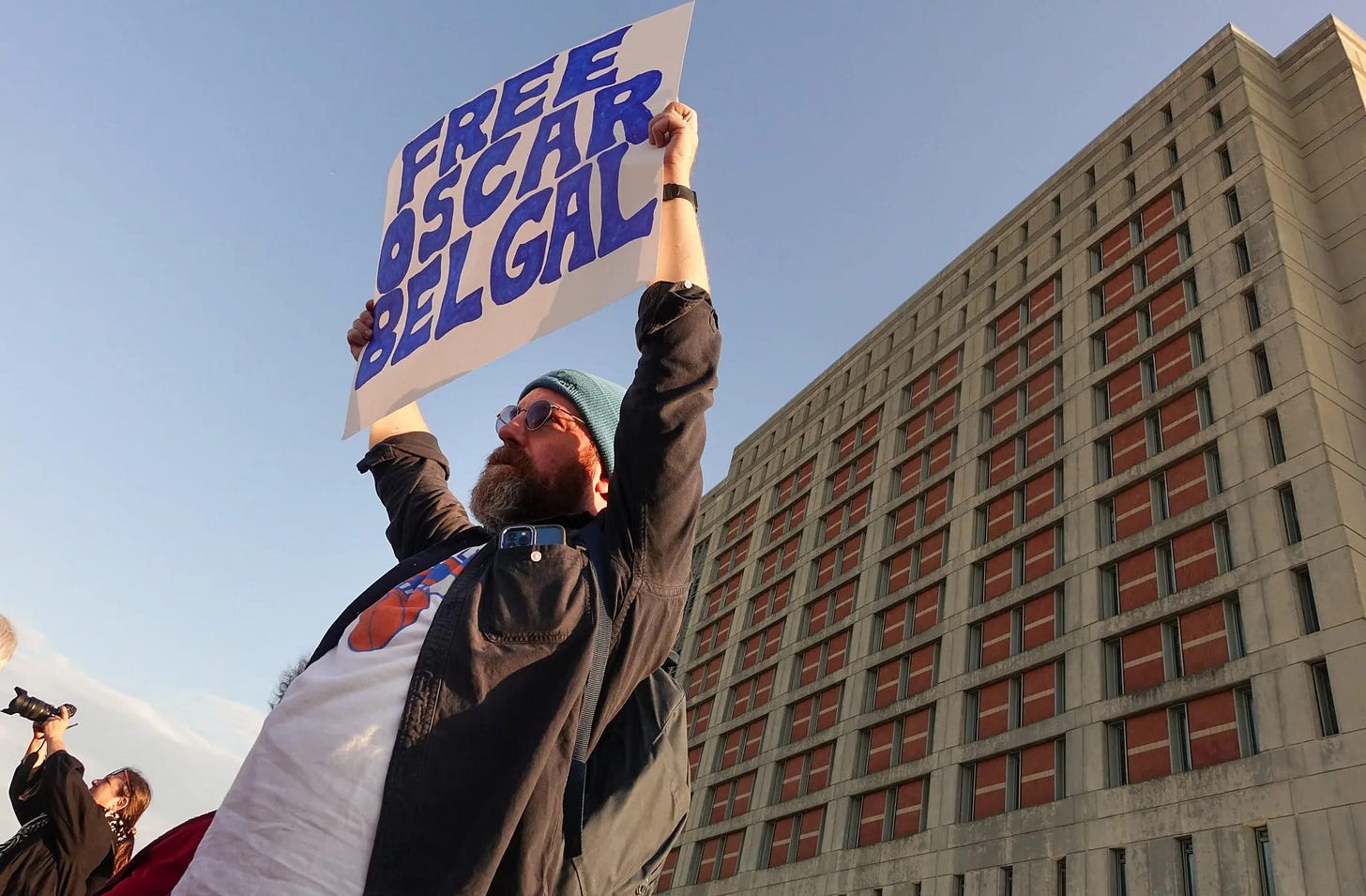 Immigrant-rights advocates protest outside the Metropolitan Detention Center while Oscar Belgal is held inside, Oct. 13, 2026. (Photo by Gwynne Hogan/The City Reporter) Immigrant-rights advocates protest outside the Metropolitan Detention Center while Oscar Belgal is held inside, Oct. 13, 2026. (Photo by Gwynne Hogan/The City Reporter)