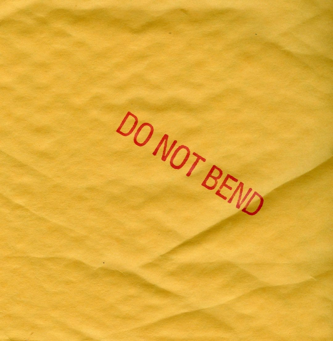 a piece of yellow paper with a red do not bed sticker on it a piece of yellow paper with a red do not bed sticker on it