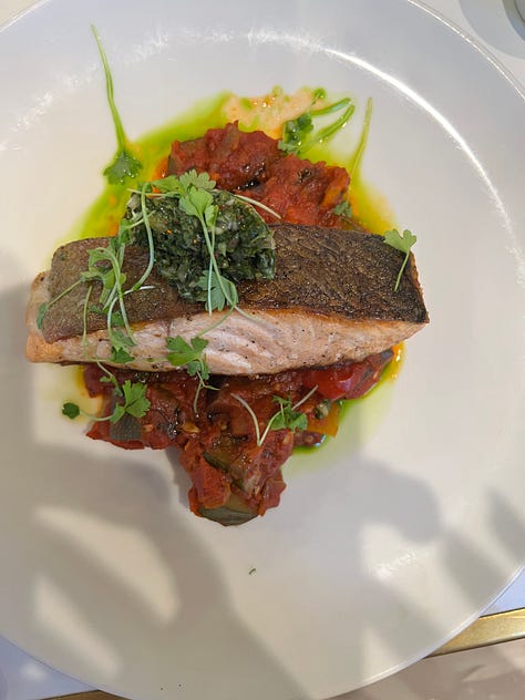 Three photos from Bouillon by Moulin: a seared salmon fillet over ratatouille, a tin of Le Guérandais sea salt on the bar, and a salmon tartare appetizer with toasted baguette on a red-rimmed bouillon plate.