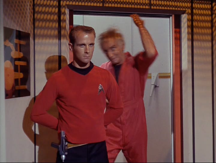 Van Gelder judo chops the security officer guarding the turbolift door.