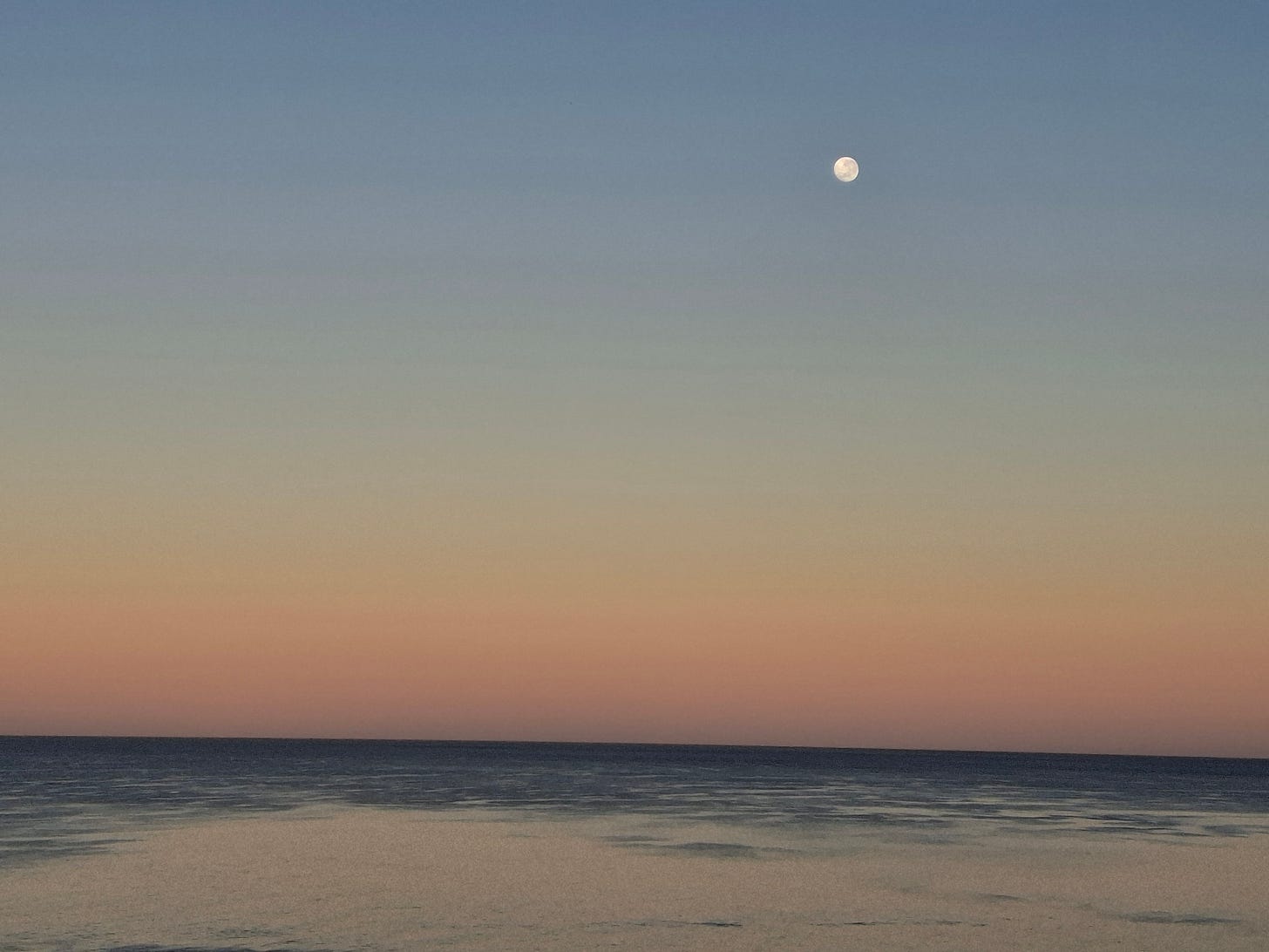 moon setting over water