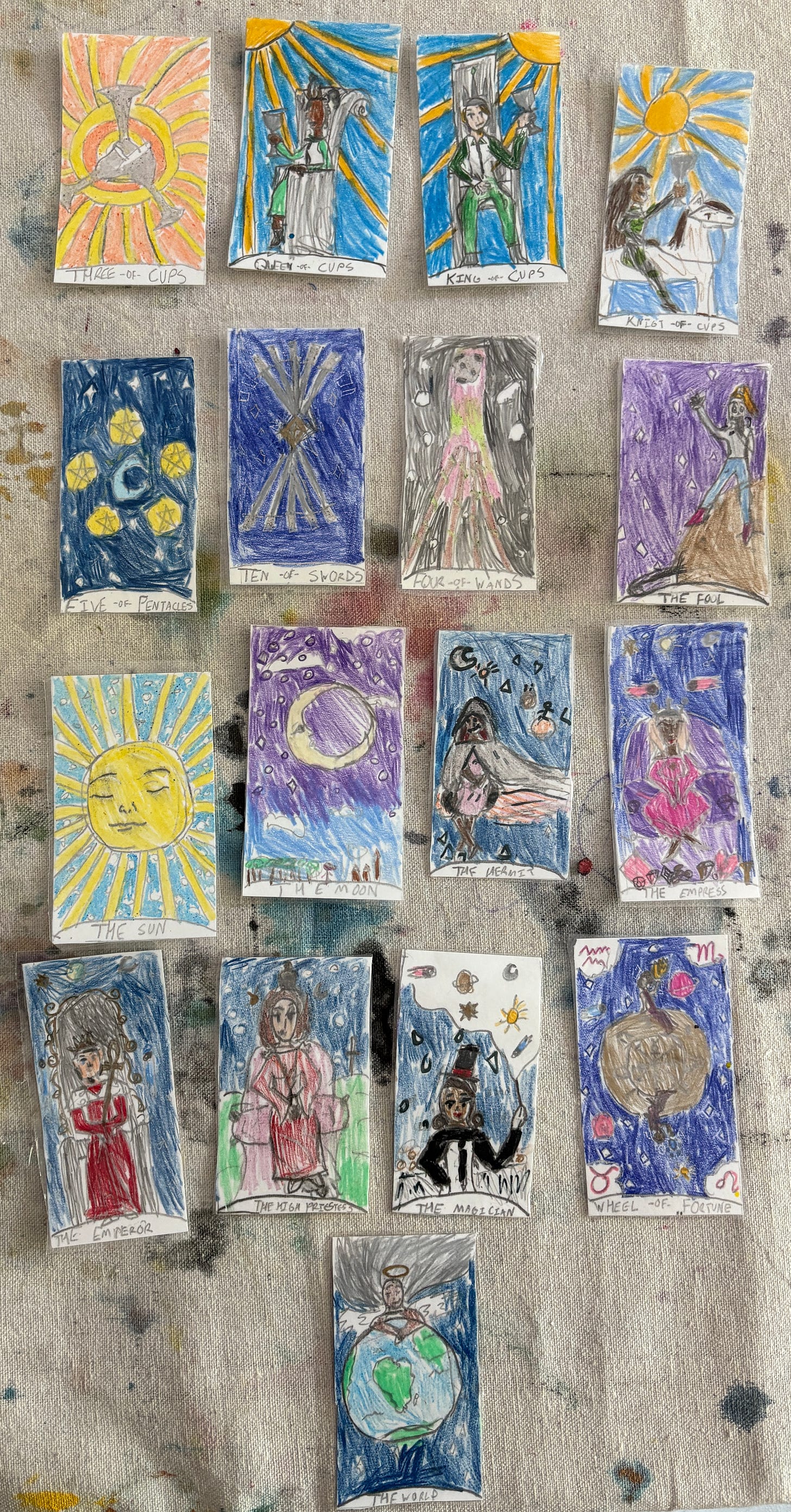 Tarot cards with celestial bodies in each card, handdrawn in color pencil.