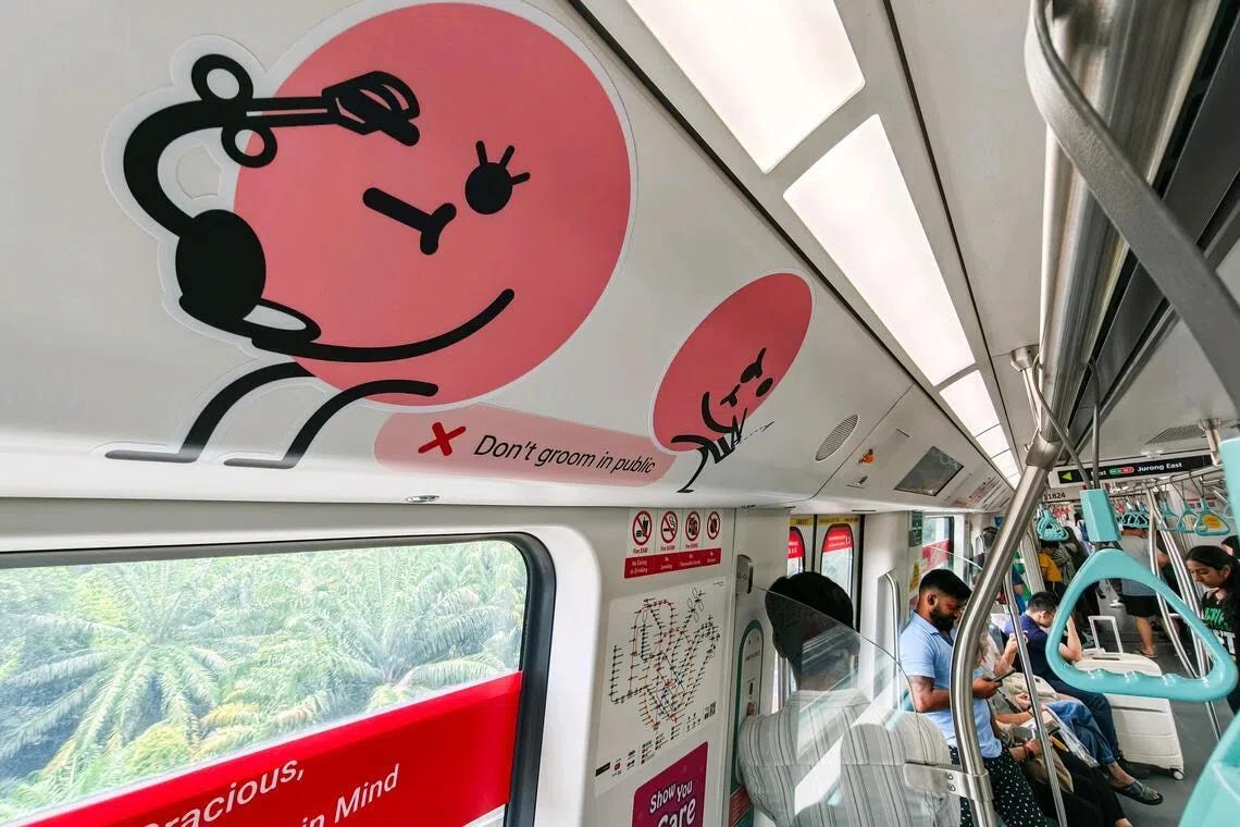 A public transport courtesy poster from SMRT Singapore featuring a cartoon woman applying makeup on a train. Bold text at the top reads "Don't groom in public."