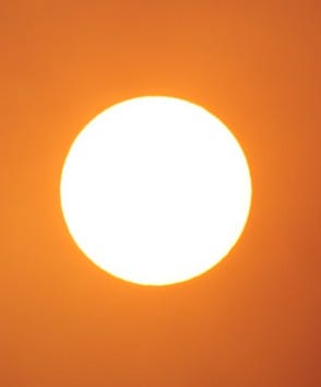 The sun shines brightly in the orange sky. The sun shines brightly in the orange sky.