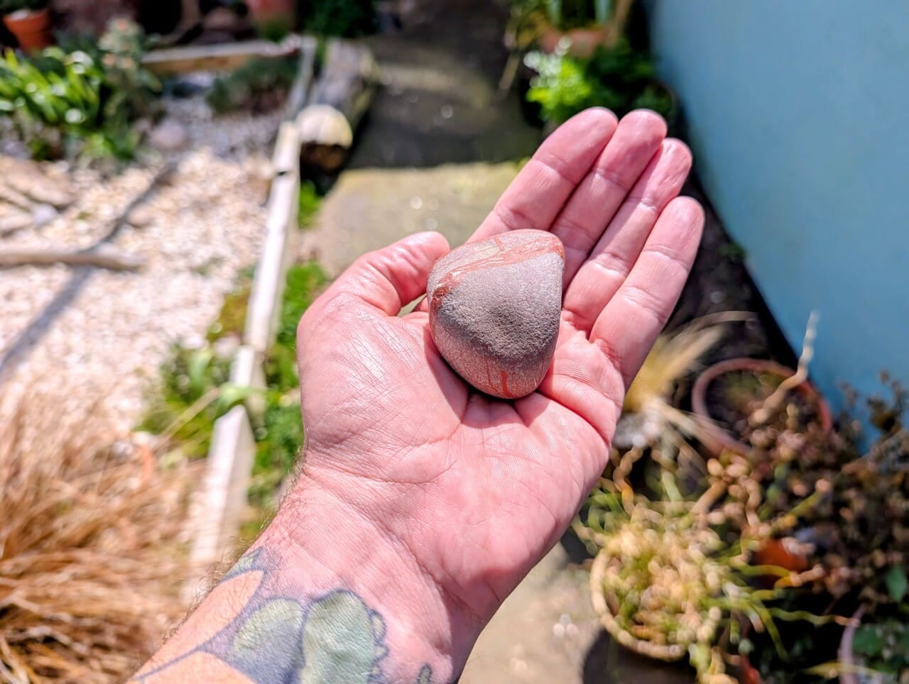 Banded stone held in hand