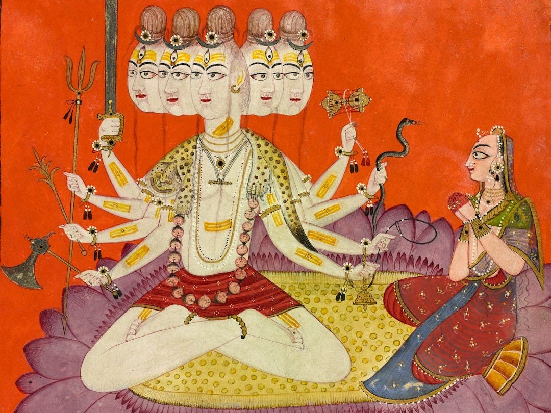 Deity with multiple heads and arms sits cross-legged. Deity with multiple heads and arms sits cross-legged.