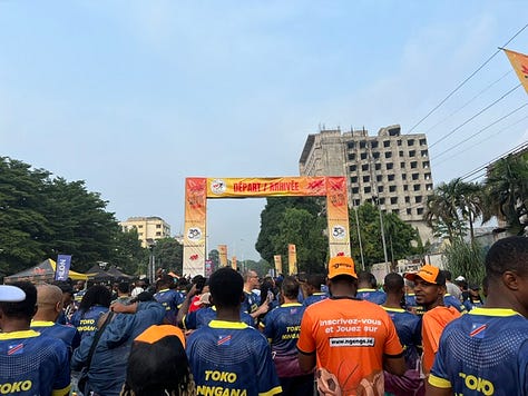 Runners are racing down a long boulevard and gathered around the starting line