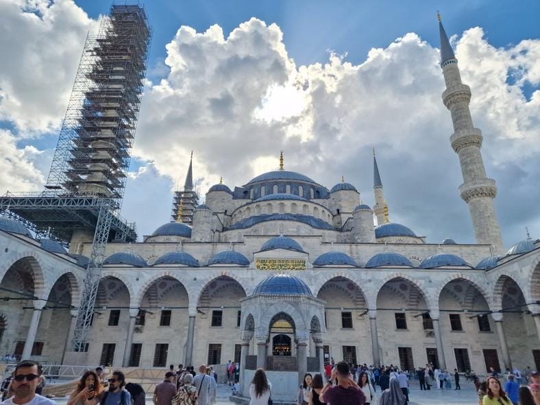 A large building with towers and people in front

AI-generated content may be incorrect.