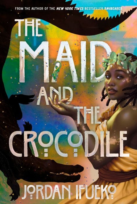 An illustrated book cover for The Maid and The Crocodile. There is a black outline of a crocodile on the left facing a Black women with vitiligo, wearing gold robes and a leaf crown.