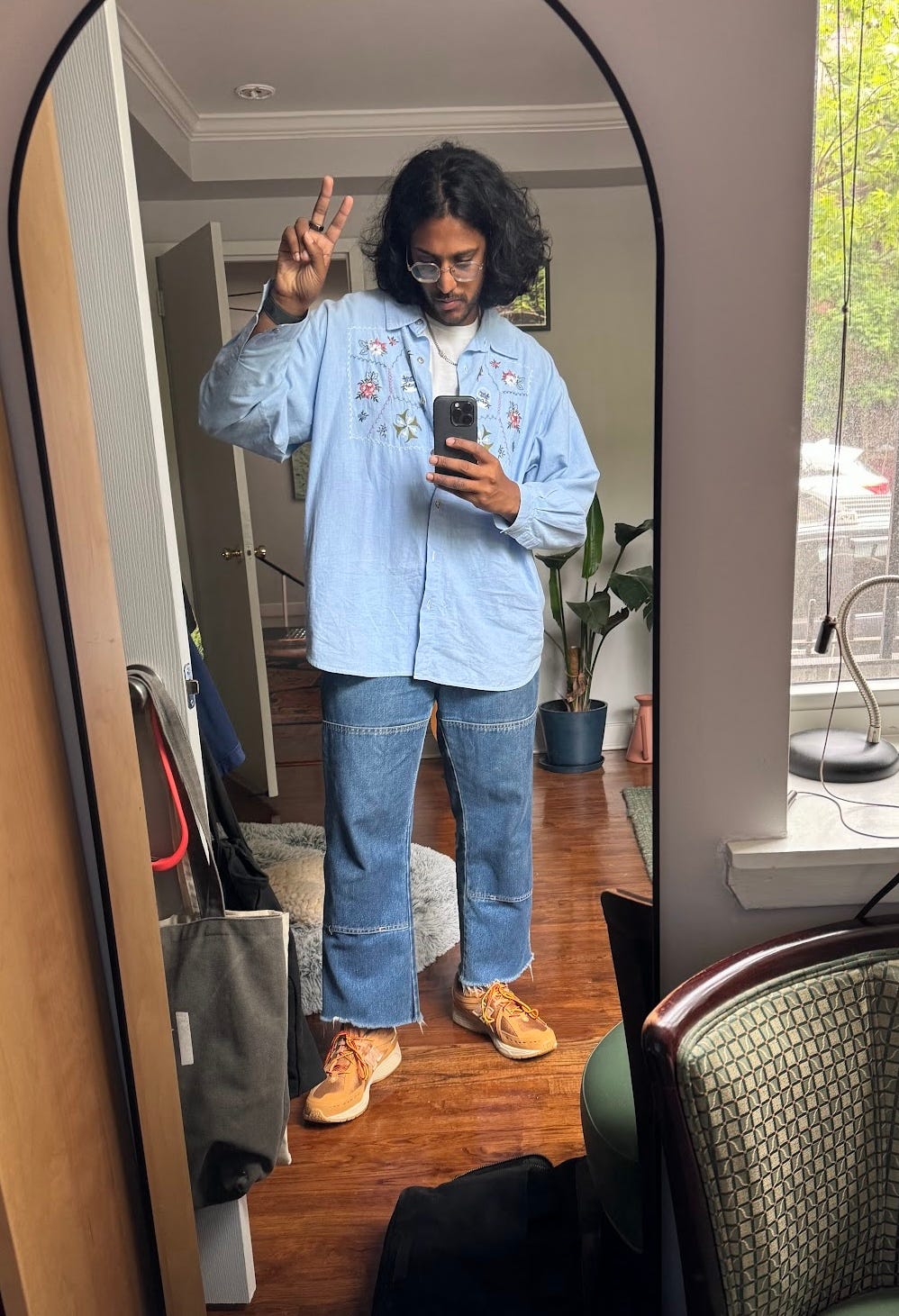 a picture of daniel making a peace sign while wearing a cool outfit